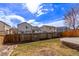 Grassy backyard with a wood fence, and a brick-edged patio at 4630 E 135Th Way, Thornton, CO 80241