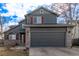 Two story home featuring a gray exterior with brick accents and a dark gray two car garage at 4630 E 135Th Way, Thornton, CO 80241