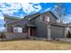 Beautiful two-story home with gray siding, red shutters, and a well-manicured lawn at 4630 E 135Th Way, Thornton, CO 80241