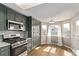 Well-lit kitchen with modern appliances, updated sage cabinetry and adjacent eat-in dining space at 4630 E 135Th Way, Thornton, CO 80241