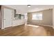 Sunlit living room showcasing hardwood floors and seamless flow into an updated kitchen space at 4630 E 135Th Way, Thornton, CO 80241