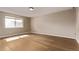 Bright living room showcasing hardwood floors, a large window, and neutral wall paint at 4630 E 135Th Way, Thornton, CO 80241