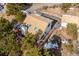 Aerial view of A-frame house in wooded area at 9189 Fallen Rock Rd, Conifer, CO 80433