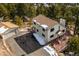 Exterior aerial showing a home with long driveway, detached garage and snowy yard at 9189 Fallen Rock Rd, Conifer, CO 80433