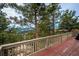 Deck with mountain views and surrounding pine trees at 9189 Fallen Rock Rd, Conifer, CO 80433