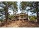 Three-story home with expansive wooden decks and natural surroundings at 9189 Fallen Rock Rd, Conifer, CO 80433