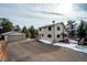 House exterior showcasing a two-story home, detached garage, and driveway at 9189 Fallen Rock Rd, Conifer, CO 80433