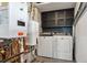 Laundry room with washer, dryer, and modern metal cabinets at 9189 Fallen Rock Rd, Conifer, CO 80433