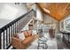 Living room with vaulted ceilings, fireplace and view into dining area at 9189 Fallen Rock Rd, Conifer, CO 80433