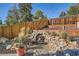 Serene backyard waterfall with lush greenery, rock accents, and a charming garden setting at 975 S Queen Way, Lakewood, CO 80226