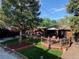 Aerial view of a backyard with a patio, a lush lawn, and a beautifully landscaped area at 975 S Queen Way, Lakewood, CO 80226