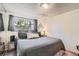 Comfortable bedroom with a large bed and a window view at 975 S Queen Way, Lakewood, CO 80226