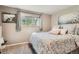Bright bedroom with a floral bedspread and a large window at 975 S Queen Way, Lakewood, CO 80226