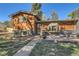 Exterior shot showcasing the beautiful woodwork, brick details, and landscaped front yard with inviting porch seating at 975 S Queen Way, Lakewood, CO 80226