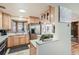 Functional kitchen featuring wood cabinets, stainless steel appliances, a bay window, and ample counter space at 975 S Queen Way, Lakewood, CO 80226