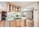 Charming kitchen featuring light wood cabinets, modern countertops, and a seamless cooktop at 975 S Queen Way, Lakewood, CO 80226