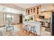 Bright kitchen featuring a breakfast bar with seating, light wood cabinets and stainless steel appliances at 975 S Queen Way, Lakewood, CO 80226