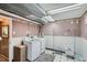 Spacious laundry room features modern washer/dryer, organized shelving and a clean, functional design at 975 S Queen Way, Lakewood, CO 80226