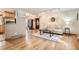 Cozy living room showcasing hardwood floors, neutral tones, and an open layout to the dining area and kitchen at 975 S Queen Way, Lakewood, CO 80226