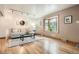 Inviting living room with hardwood floors, stylish lighting, a comfortable couch, and a large bay window at 975 S Queen Way, Lakewood, CO 80226