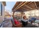 Covered patio with seating area and fire pit at 19805 E 58Th Pl, Aurora, CO 80019