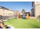 Artificial turf backyard with mature tree and lighting at 19805 E 58Th Pl, Aurora, CO 80019