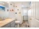 Main floor bathroom with single sink vanity and laundry area at 19805 E 58Th Pl, Aurora, CO 80019