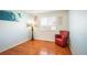 Cozy bedroom featuring hardwood floors and a comfortable armchair at 19805 E 58Th Pl, Aurora, CO 80019