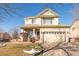 Two-story house with attached garage and landscaping at 19805 E 58Th Pl, Aurora, CO 80019