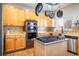Modern kitchen featuring stainless steel appliances and wood cabinets at 19805 E 58Th Pl, Aurora, CO 80019