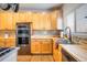 Kitchen with stainless steel appliances and wood cabinets at 19805 E 58Th Pl, Aurora, CO 80019