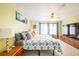 Main bedroom with king bed, TV, and large window at 19805 E 58Th Pl, Aurora, CO 80019