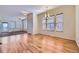 Open concept dining room featuring hardwood floors, large windows and chandelier lighting at 11925 W Ida Dr, Littleton, CO 80127