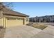 Exterior of home featuring two-car garage and close proximity to other buildings at 11925 W Ida Dr, Littleton, CO 80127