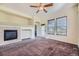 Cozy living room with a tile surround fireplace, carpet, and natural light at 11925 W Ida Dr, Littleton, CO 80127