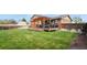 Expansive backyard with a well-maintained lawn, a deck with a pergola, and a privacy fence for serene outdoor living at 4510 E 121St Pl, Thornton, CO 80241