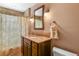 Bathroom features a granite countertop, dark wood cabinet and decorative mosaic tile backsplash at 4510 E 121St Pl, Thornton, CO 80241