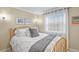 Cozy bedroom featuring a full-sized bed, white linen, and natural light from the sheer-curtained window at 4510 E 121St Pl, Thornton, CO 80241