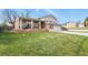 Well-manicured front lawn of a two-story home with brick and siding exterior and an attached garage at 4510 E 121St Pl, Thornton, CO 80241