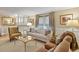 Comfortable living room featuring plush seating, elegant decor, and natural light from the window at 4510 E 121St Pl, Thornton, CO 80241