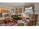 Cozy living room area features a brick fireplace, wood trim and comfortable seating at 4510 E 121St Pl, Thornton, CO 80241