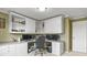 Spacious home office featuring a desk area, custom cabinets, and large windows at 4510 E 121St Pl, Thornton, CO 80241