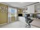 Home office features a desk, built in shelving, and large windows that offer a view of the outdoors at 4510 E 121St Pl, Thornton, CO 80241