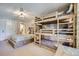 Bedroom featuring a rustic bunk bed, queen bed and neutral tones at 815 Columbine Rd # 22, Breckenridge, CO 80424