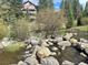 Scenic creek with rocks and view of the building in the background at 815 Columbine Rd # 22, Breckenridge, CO 80424