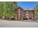 Attractive condo building with wood beam accents and private balconies, nestled among mature trees at 815 Columbine Rd # 22, Breckenridge, CO 80424