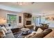 Bright living room with a fireplace, cozy sectional, dining area, and views of the surrounding trees at 815 Columbine Rd # 22, Breckenridge, CO 80424
