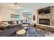 Inviting living room with a stone fireplace, plush sofa, and a window showcasing nature at 815 Columbine Rd # 22, Breckenridge, CO 80424