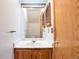 Cozy bathroom featuring a vanity with a sink and a framed mirror, perfect for daily routines at 4203 Owens St, Wheat Ridge, CO 80033