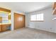 Carpeted bedroom with a large closet, window, and vanity area, offering plenty of space at 4203 Owens St, Wheat Ridge, CO 80033